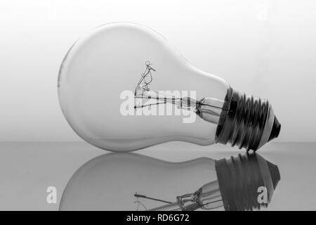 Old bulb filament isolated backlit on white background, conceptual image Stock Photo