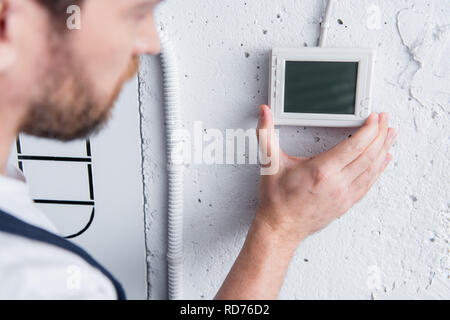 partial view of male handyman checking electrical panel Stock Photo