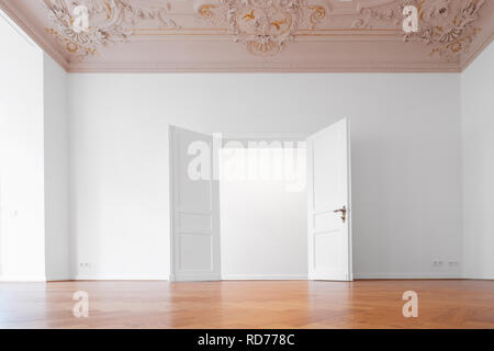 open  door in empty room of historic apartment after refurbishment - Stock Photo