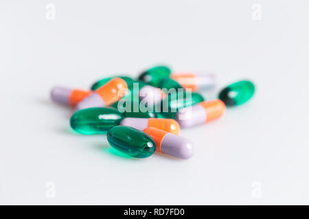 Close up to pills, tablets and capsules isolated in gray background Stock Photo