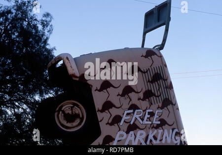 FREE PARKING SIGN ON AN OLD OVER-TURNED BUS COVERED WITH KANGAROO PICTURES, SILVERTON, OUTBACK NEW SOUTH WALES, AUSTRALIA Stock Photo