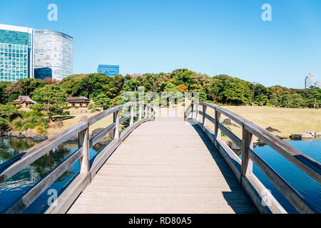 Hamarikyu Gardens wooden bridge and pond in Tokyo, Japan Stock Photo