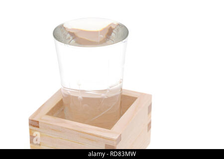 Japanese wooden box masu with sake isolated on white background Stock Photo