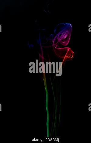 Coloured smoke against a black background Stock Photo