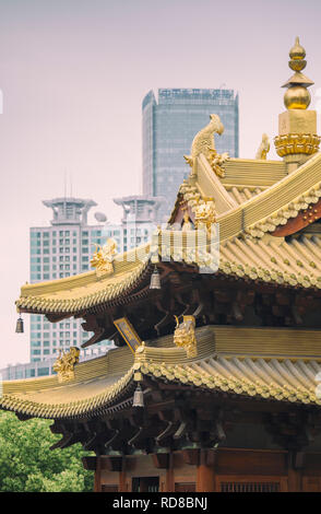 Jing'an Temple in Shanghai, China, with modern office buildings in the background Stock Photo