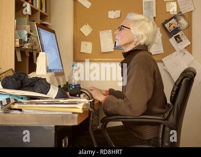 Senior woman working from home. Stock Photo