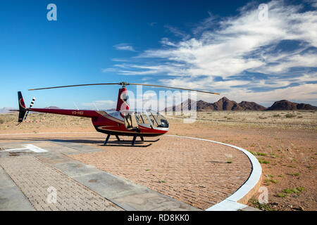 R44 Raven II Helicopter at Sossusvlei Lodge Adventure Centre near Namib-Naukluft National Park, Namibia, Africa Stock Photo