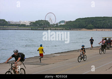 People jogging and riding bikes on Navy Pier in Chicago, IL, USA Stock Photo