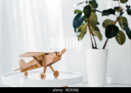 wooden plane model on white table at home Stock Photo