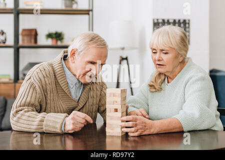 senior couple playing with wooden blocks at home Stock Photo