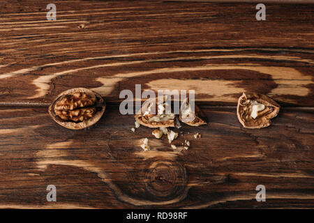 top view of walnuts in nut shells as dementia symbol on wooden table Stock Photo