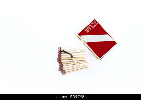 Portrait of one burned matchstick on the open matches with box. Isolated on the white background. Stock Photo