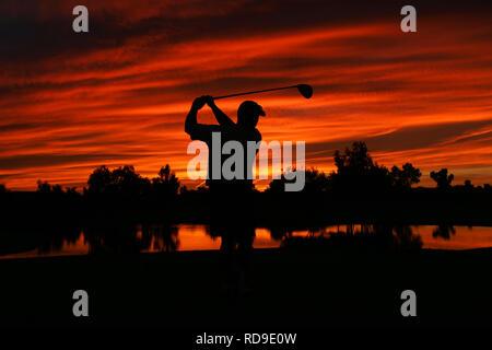 A silhouette of a golfer at the end of his stroke during sunset in Phoenix, Arizona. Stock Photo