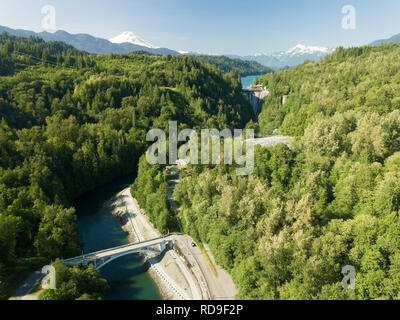 An aerial view of the Henry Thompson Bridge in Concrete, Washington. The Concrete Dam, Lake Shannon, and Mt. Baker are visible in the background. Stock Photo