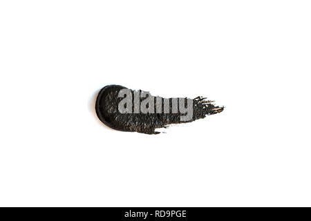 Black clay mask isolated on white background. Stock Photo