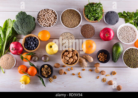 Healthy food clean eating : fruit, vegetable, seeds, superfood, cereals, leaf vegetable on black wood background with copy space, top view. Stock Photo