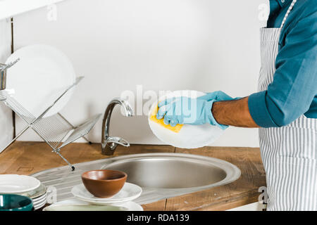 cropped image of mature man washing dishes in kitchen Stock Photo