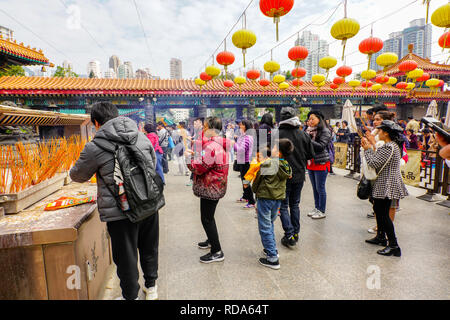 The Main Altar. The Sik Sik Yuen Wong Tai Sin Temple Hong Kong. Worshippers light worship sticks at the alter before making a wish. Stock Photo