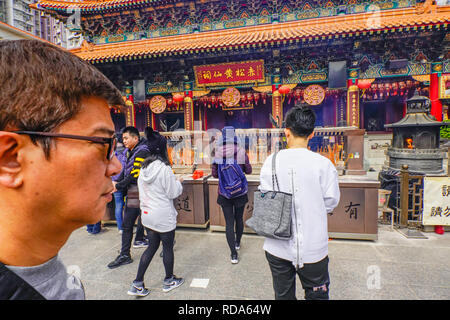 The Main Altar. The Sik Sik Yuen Wong Tai Sin Temple Hong Kong. Worshippers light worship sticks at the alter before making a wish. Stock Photo