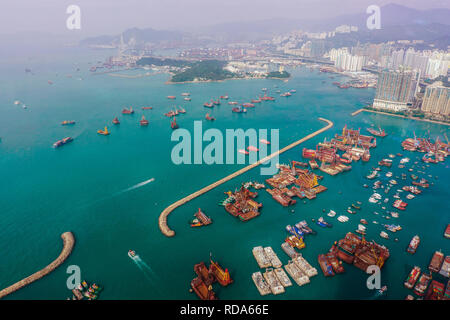 Aerial view of Victoria Harbour with urban skyscrapers and sea. Hong Kong, China. Stock Photo