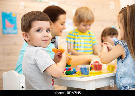 Plasticine modeling clay. Child dough play in school mold from plasticine  in kindergarten .Kids knead modeling clay with hands in preschool Stock  Photo - Alamy