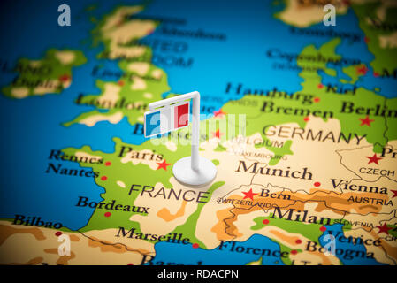 France marked with a flag on the map Stock Photo - Alamy