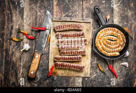 Grilled sausages. on a wooden background Stock Photo