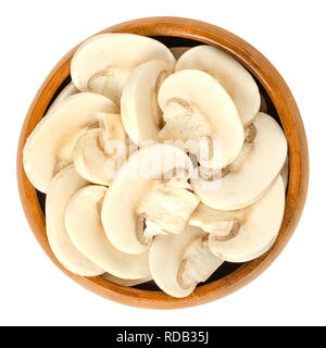 Sliced white champignon mushrooms in wooden bowl. Agaricus bisporus, also called common, button, cultivated or table mushroom. Stock Photo