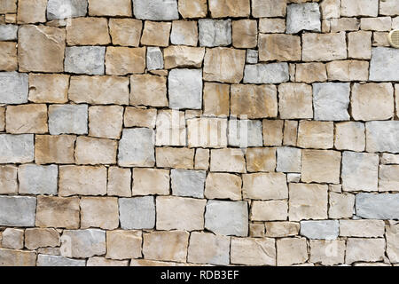 Light warm yellow sandstone wall made of square blocks. Stock Photo