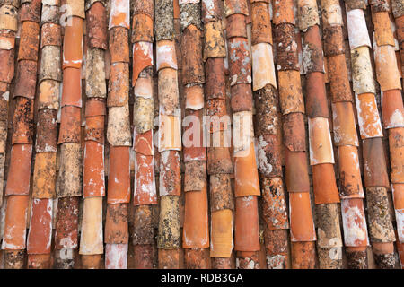 Old red, orange and beige mediterranean roof tiles. Stock Photo