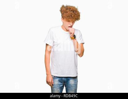 Young handsome man with afro hair wearing casual white t-shirt feeling unwell and coughing as symptom for cold or bronchitis. Healthcare concept. Stock Photo