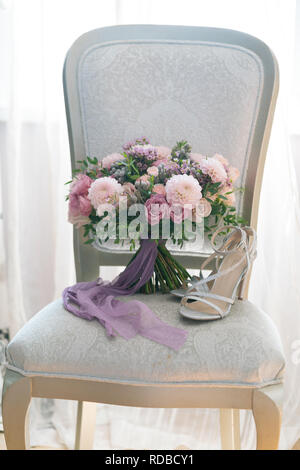 pink and lilac wedding bouquet stands on a chair Stock Photo