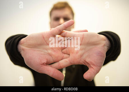 Man clicking his knuckles Stock Photo