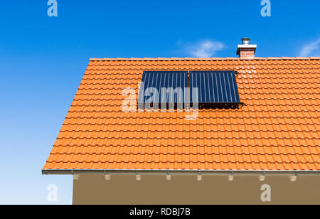 thermal power plant on a red tiled roof of a house Stock Photo