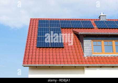 solar panels or photovoltaic power plant on a red tiled roof Stock Photo