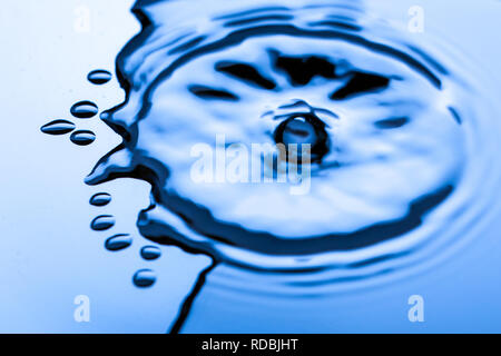 Blue water droplets on a shiny surface Stock Photo