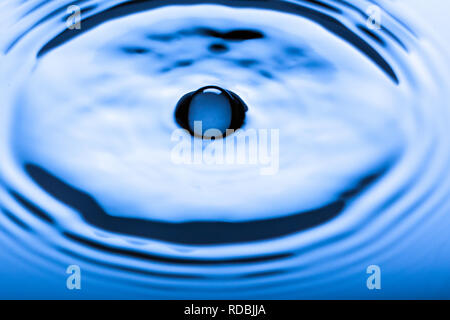 Blue water droplets on a shiny surface Stock Photo