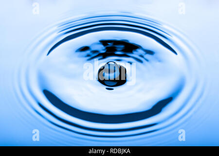 Blue water droplets on a shiny surface Stock Photo