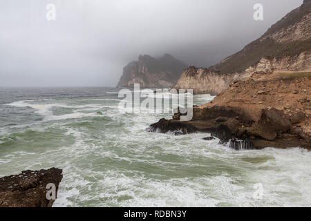 The rugged coastline of Mughsayl, near Salalah, Dhofar Province, Oman, during Khareef monsoon season Stock Photo