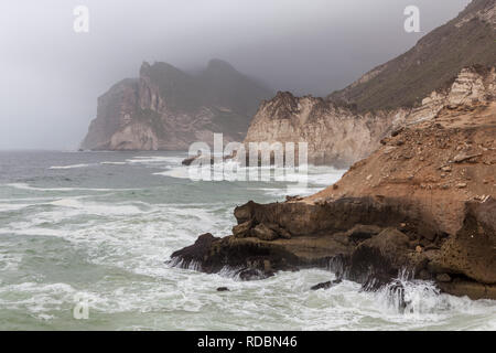 The rugged coastline of Mughsayl, near Salalah, Dhofar Province, Oman, during Khareef monsoon season Stock Photo