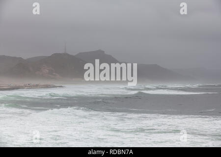 The rugged coastline of Mughsayl, near Salalah, Dhofar Province, Oman, during Khareef monsoon season Stock Photo