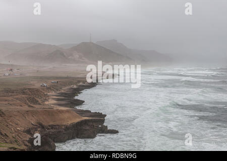 The rugged coastline of Mughsayl, near Salalah, Dhofar Province, Oman, during Khareef monsoon season Stock Photo