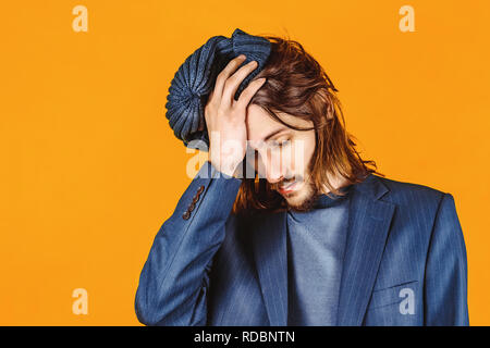 people, health problem and stress concept - unhappy indian man suffering from headache over grey background Stock Photo