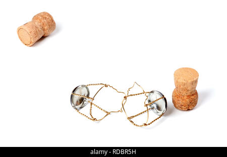 Two corks from champagne wine and muselets. Isolated on white background with copy space. Selective focus. Stock Photo