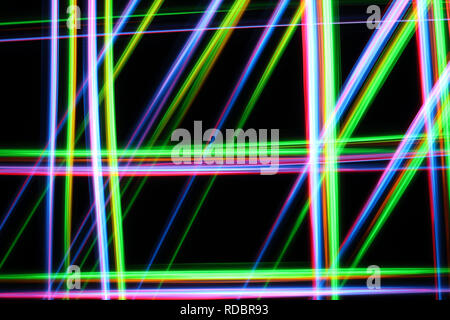 A colorful and glowing light painting abstract image with red, green, blue and yellow blurry lines over a black background, creating a net Stock Photo