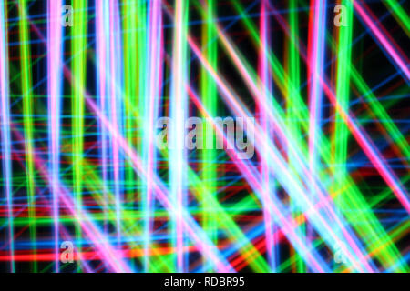 A colorful and glowing light painting abstract image with red, green, blue and yellow blurry lines over a black background, creating a net Stock Photo