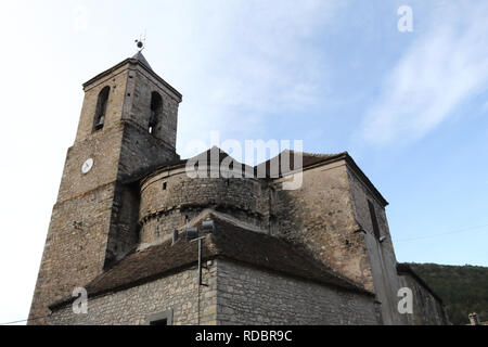 The stone made, modern Saint Martin's church (Iglesia de San Martin) and its bell tower with clock in the rural village of Hecho, Aragon, Spain Stock Photo