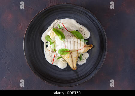 Fried fillet of white fish with rice and green beans decorated with chard Stock Photo
