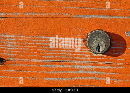 rusty lock and peeling paint on a beach cabin with distressed wood grain in winter in Italy on the Adriatic coast Stock Photo