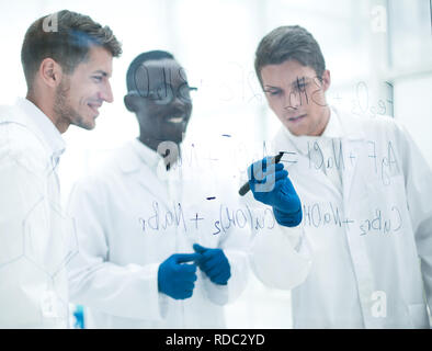 promising scientist makes notes on the Board Stock Photo